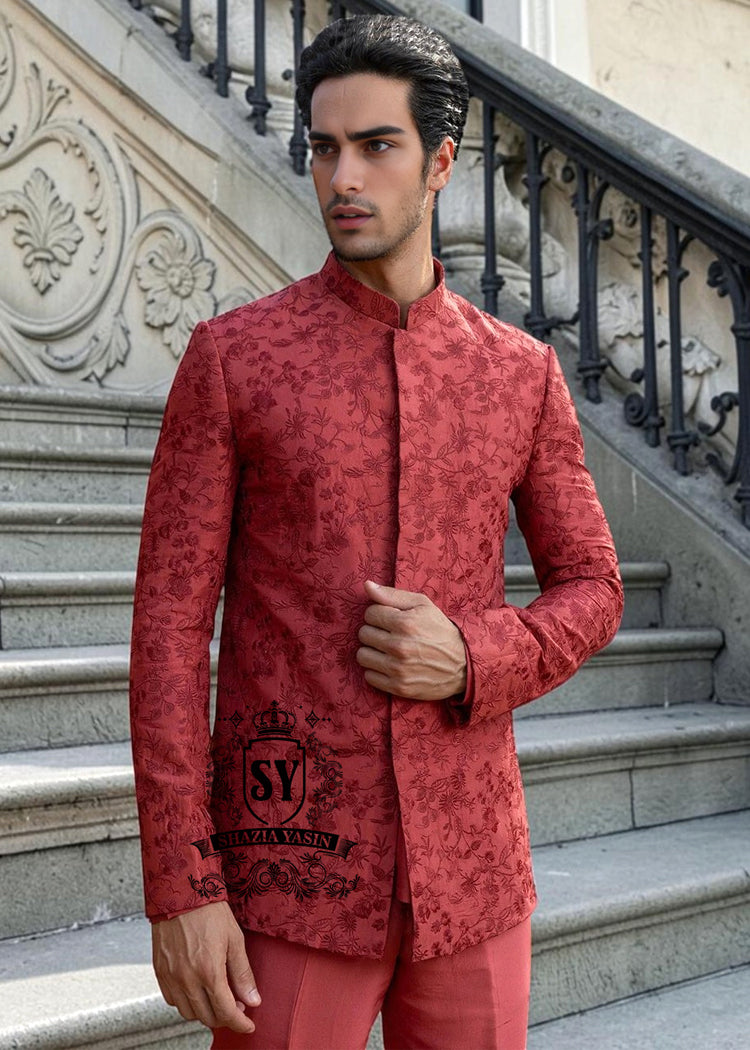 This Prince Coat embodies a mastery of proportion and structure. The prince coat, crafted from pure raw silk, features brick-red embroidery. Beneath it lies a silhouette that flows from a soft kurta to sharp, slim-fitting trousers.