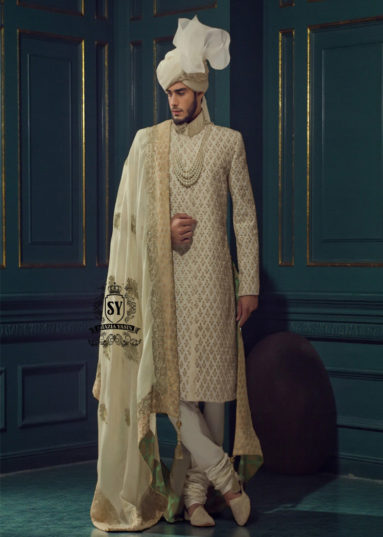 This cream-colored Sherwani suit from Shazia Yasin is the ideal choice for the modern groom. Classic, stylish, and perfectly tailored – for an unforgettable appearance on your big day.