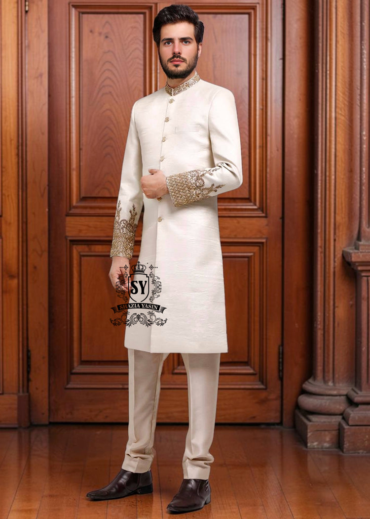 An off-white sherwani design imbued with artistic spirit, every detail meticulously crafted to celebrate the elegant beauty of the groom. The combined with delicate buttons running down the center, creating a focal point that is both classic and modern.