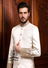 An off-white sherwani design imbued with artistic spirit, every detail meticulously crafted to celebrate the elegant beauty of the groom. The combined with delicate buttons running down the center, creating a focal point that is both classic and modern.