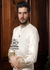An off-white sherwani design imbued with artistic spirit, every detail meticulously crafted to celebrate the elegant beauty of the groom. The combined with delicate buttons running down the center, creating a focal point that is both classic and modern.