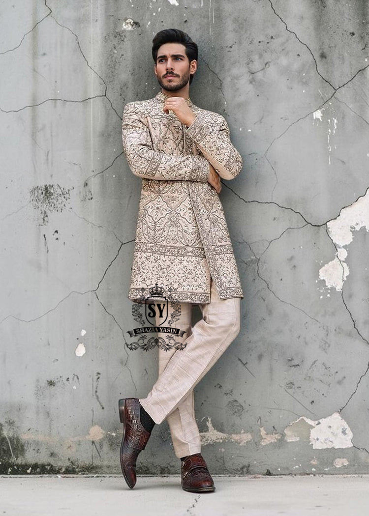 This Sherwani dress will charm everyone with its elegance and exquisiteness. The Blanched Almond color adds a touch of brightness, and beautiful jeweled work border on the front and along the hem creates a feeling of luxury and sophistication.