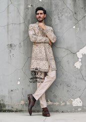 This Sherwani dress will charm everyone with its elegance and exquisiteness. The Blanched Almond color adds a touch of brightness, and beautiful jeweled work border on the front and along the hem creates a feeling of luxury and sophistication.