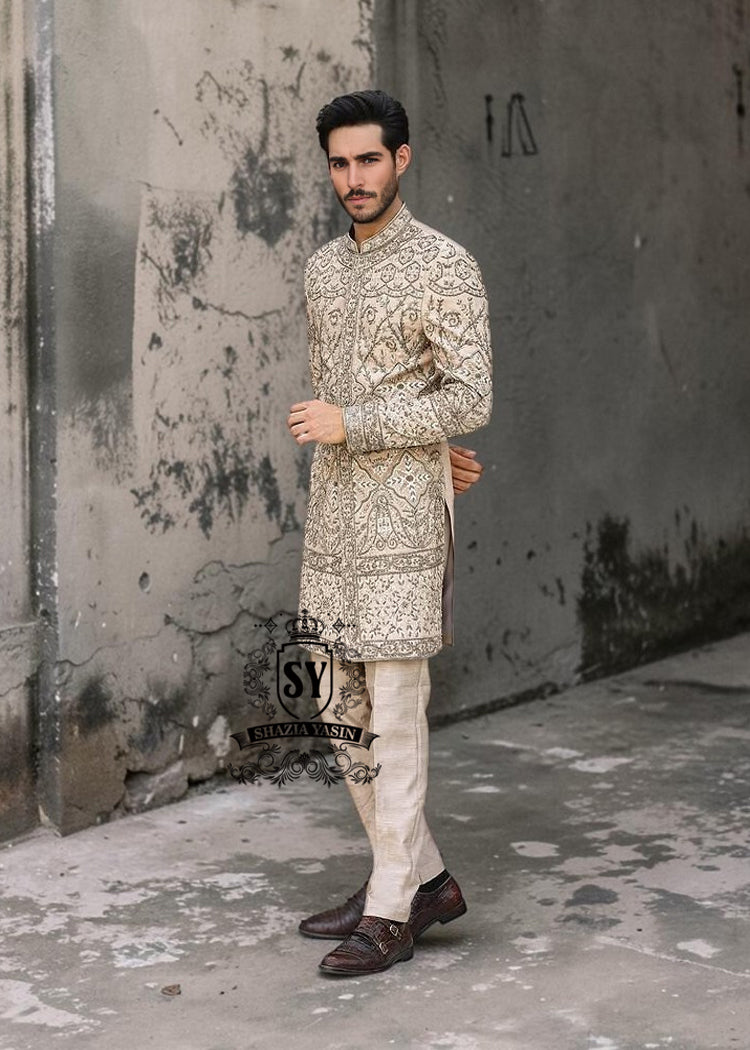 This Sherwani dress will charm everyone with its elegance and exquisiteness. The Blanched Almond color adds a touch of brightness, and beautiful jeweled work border on the front and along the hem creates a feeling of luxury and sophistication.