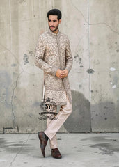 This Sherwani dress will charm everyone with its elegance and exquisiteness. The Blanched Almond color adds a touch of brightness, and beautiful jeweled work border on the front and along the hem creates a feeling of luxury and sophistication.