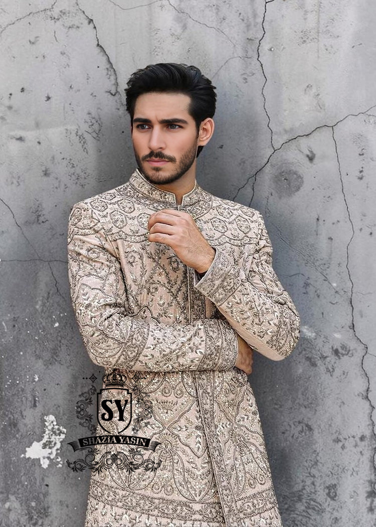 This Sherwani dress will charm everyone with its elegance and exquisiteness. The Blanched Almond color adds a touch of brightness, and beautiful jeweled work border on the front and along the hem creates a feeling of luxury and sophistication.