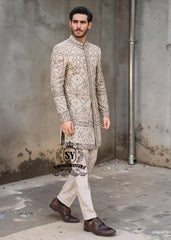This Sherwani dress will charm everyone with its elegance and exquisiteness. The Blanched Almond color adds a touch of brightness, and beautiful jeweled work border on the front and along the hem creates a feeling of luxury and sophistication.