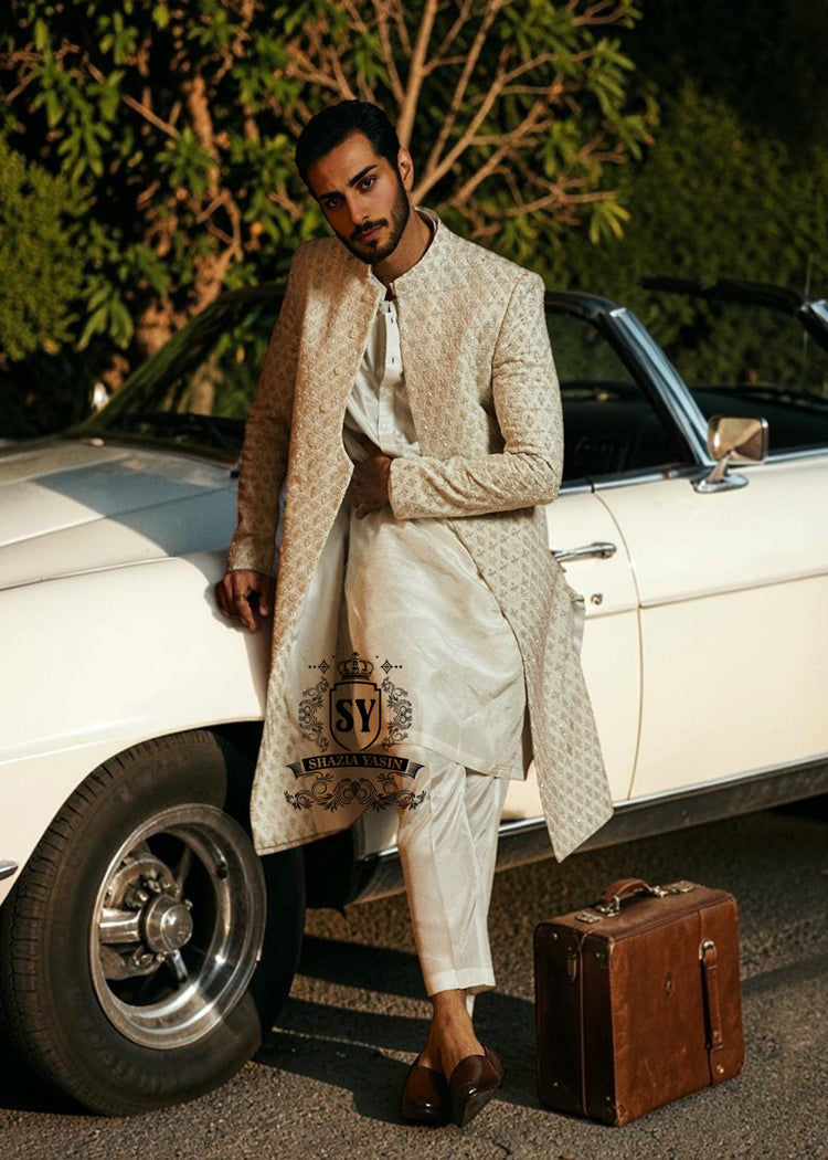 Pure royalty. A finely hand-embroidered sherwani by Shazia Yasin, elevated with gold accents, paired with a statement mala and a bold crimson turban for a timeless yet striking look.