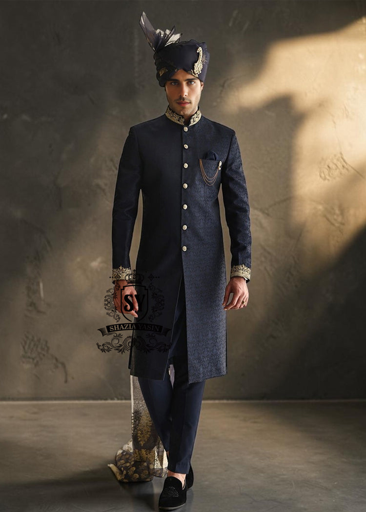 Indulge in a blissful moment with the beautiful Jets Navy Embellished Sherwani For Wedding, crafted from high-quality Jamawaar fabric. Perfect for any wedding occasion, this sherwani will make you shine on your special day.