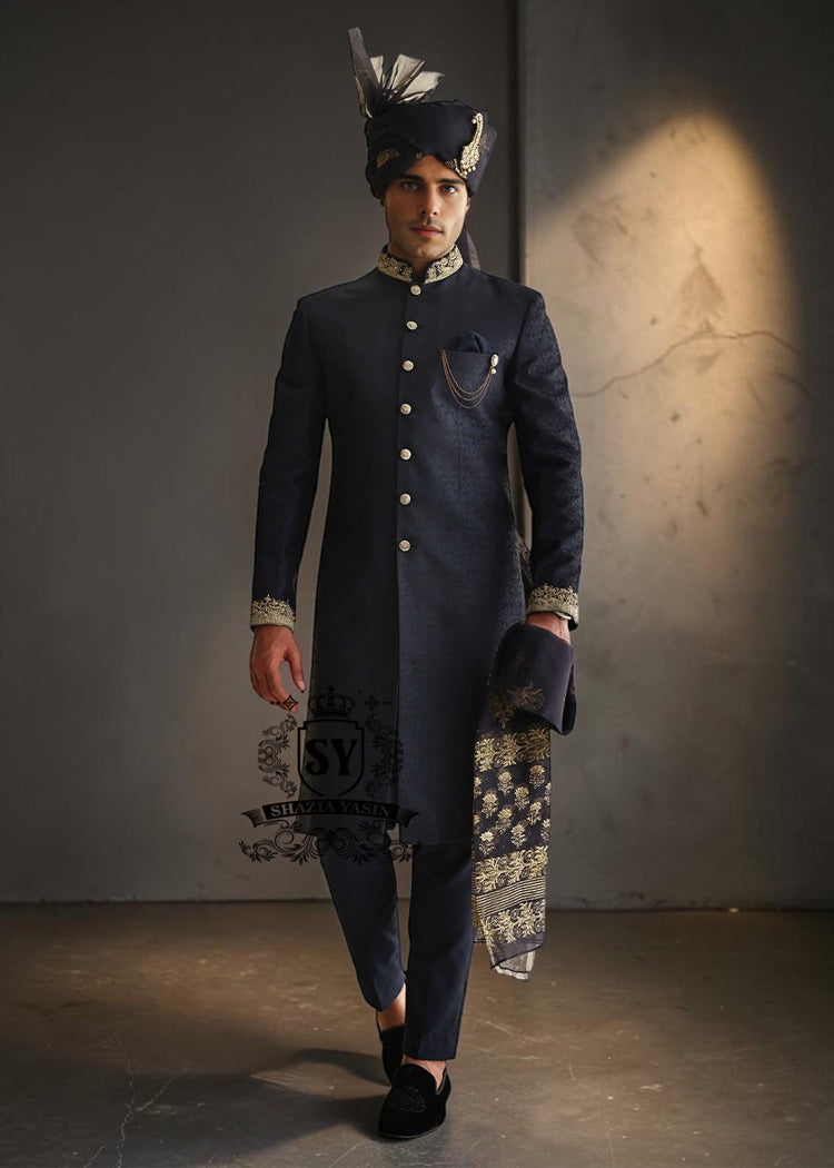 Indulge in a blissful moment with the beautiful Jets Navy Embellished Sherwani For Wedding, crafted from high-quality Jamawaar fabric. Perfect for any wedding occasion, this sherwani will make you shine on your special day.