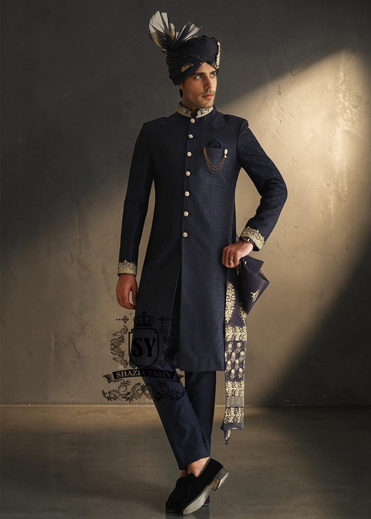 Indulge in a blissful moment with the beautiful Jets Navy Embellished Sherwani For Wedding, crafted from high-quality Jamawaar fabric. Perfect for any wedding occasion, this sherwani will make you shine on your special day.