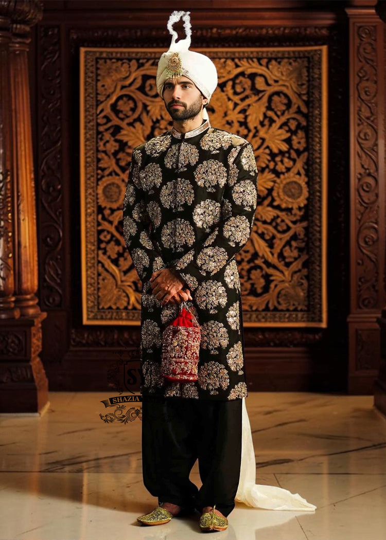 We love the striking contrast of the hand embellished sherwani and premium raw silk, which adds a touch of sophistication. The perfectly tailored cut create a spectacular silhouette for the groom seeking radiant and memorable elegance. An ultra-elegant and graceful look, perfect for a truly gentle wedding day.