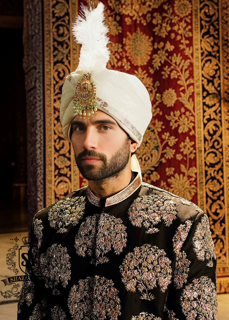 We love the striking contrast of the hand embellished sherwani and premium raw silk, which adds a touch of sophistication. The perfectly tailored cut create a spectacular silhouette for the groom seeking radiant and memorable elegance. An ultra-elegant and graceful look, perfect for a truly gentle wedding day.