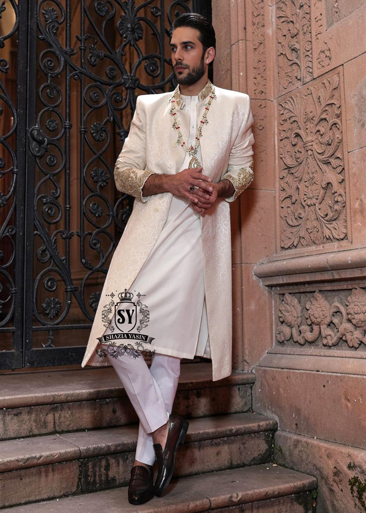 The Luminescence Ivory White Sherwani is a vision of refined romance, crafted in luminous karandi silk that seems to glow with elegance—hand embellishments on the collar and sleeves whispers of heritage artistry,