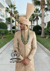 In the grandeur of royal legacy, this Taupe Gold sherwani stands as a tribute to timeless nobility. Handcrafted with intricate embroidery that echo strength and majesty, it glimmers with the delicate artistry of sequins, Swarovski crystals. A creation where tradition meets elegance - designed for the groom who carries the spirit of heritage with the poise of modern royalty.