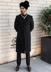 Embrace an aura of graceful distinction with our Elegant Black Sherwani, exquisitely complemented by a matching inner suit, Groom's necklace, and turban. This traditional wedding sherwani captures the very essence of refined elegance, seamlessly intertwining tradition with modern allure.