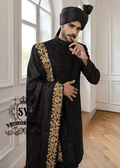 This men's wedding Sherwani is the perfect choice for the groom who wants a refined, modern, and impeccable look on his most important day. The tailored black Sherwani suit elegantly accentuates his figure, while the classic  shawl adds a unique and sophisticated touch.